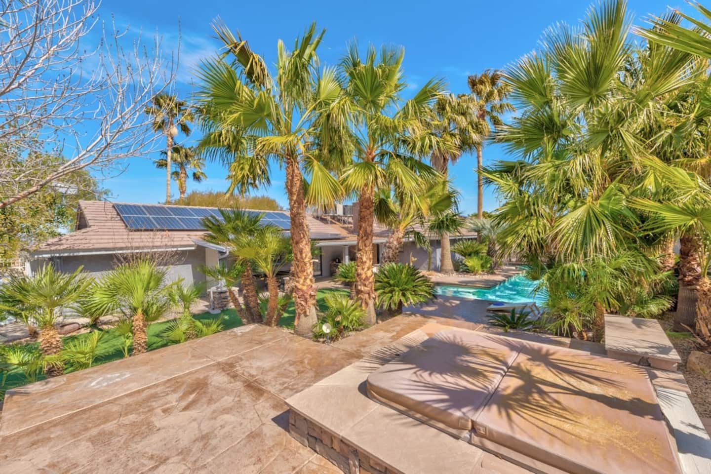Relax in the raised, covered private spa, surrounded by a lush grove of towering palm trees. This upper patio area offers a beautiful view of the lower swimming pool and provides a secluded, tropical 
