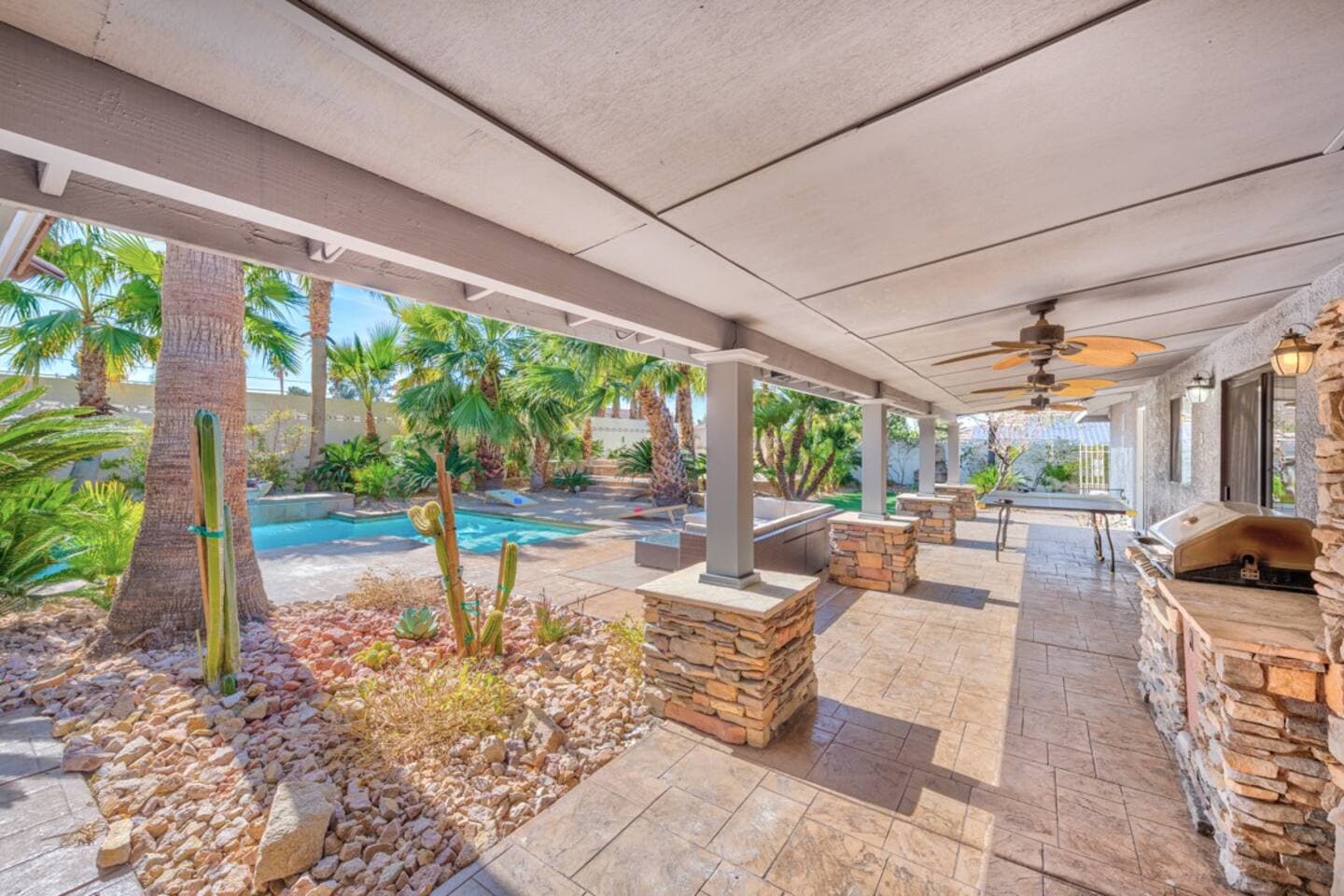  Enjoy alfresco living under this expansive covered patio! It features a fully-equipped built-in BBQ and outdoor kitchen with ample counter space. Relax in the shade while overlooking the sparkling pr